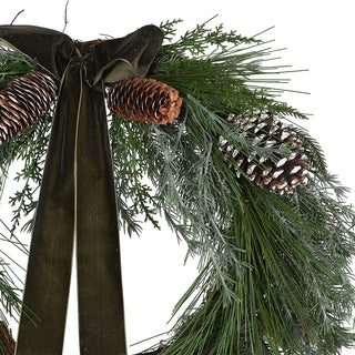 Close up of frosted pinecones and olive velvet bow on the Kielder wreath