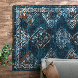 Zola Kian traditional rug in blue and green styled in a living room