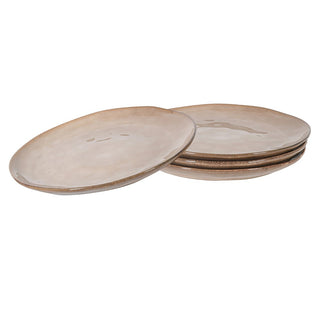 Organic natural stoneware dinner plates set of four with neutral beige glaze stacked on a white background
