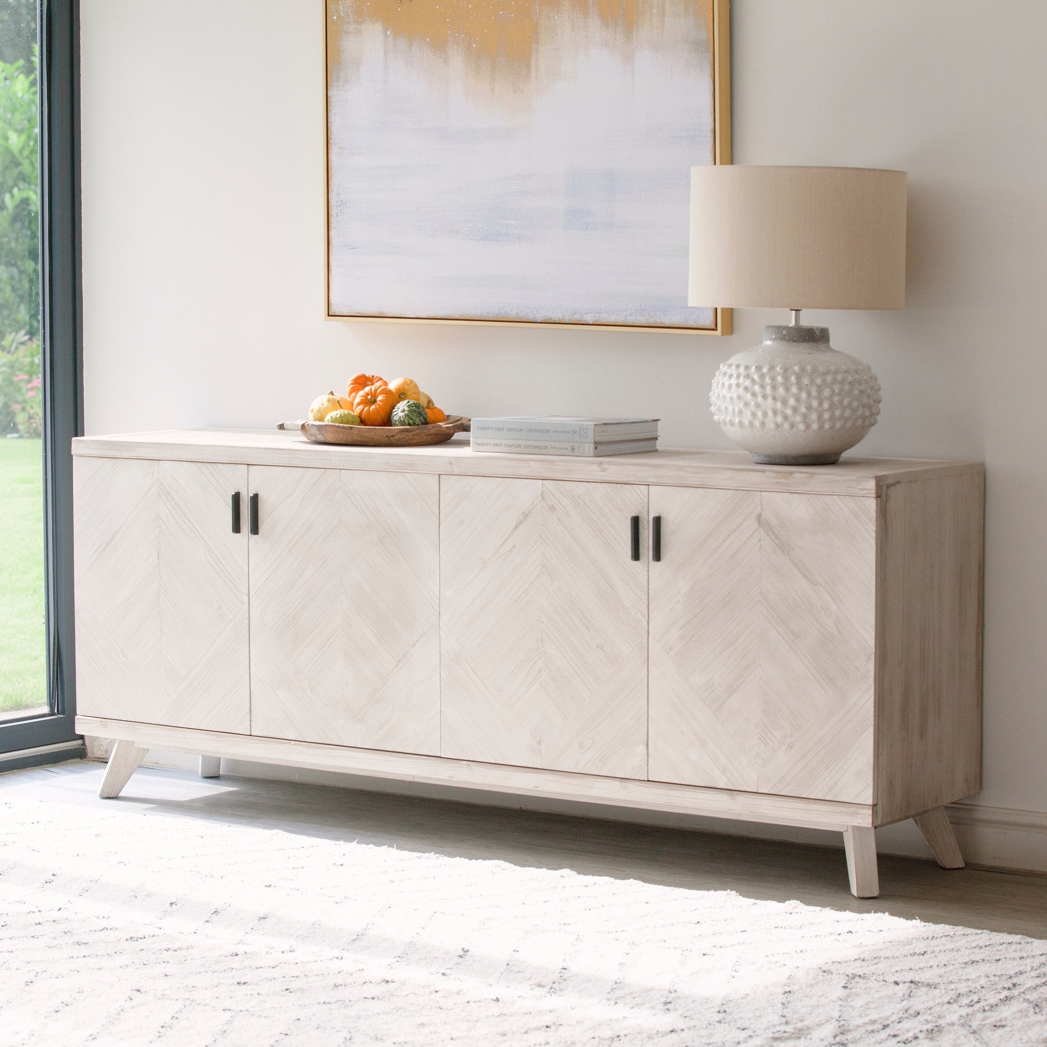 Parquet sideboard styled in a living room with lamp and décor