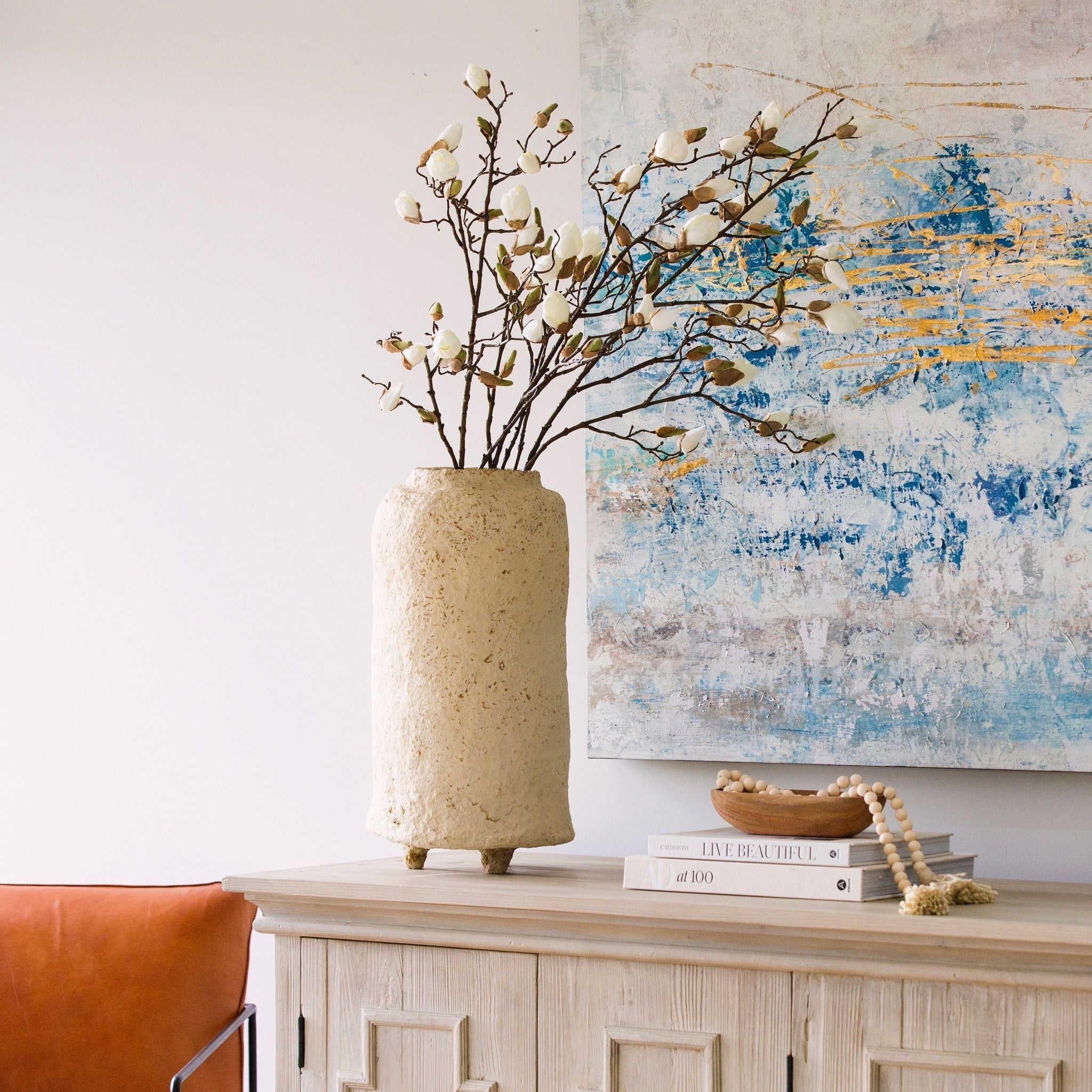 A beautiful stem of magnolia featuring bud detailing and blooming flowers.