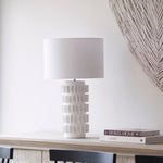 Samsara Table Lamp with white textured ceramic base and fabric drum shade on console table