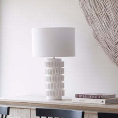 Samsara Table Lamp with white textured ceramic base and fabric drum shade on console table