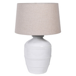 This luxuriously crafted lamp features a white ceramic base adorned with intricate beading, and accompanied by a natural linen shade.