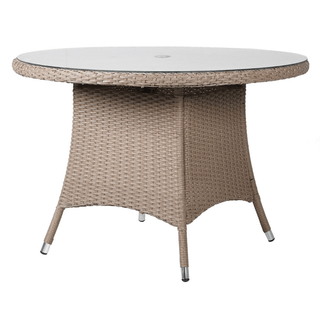 Round outdoor table with wicker frame and white top on a white background