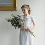 A bouquet of berry and green eucalyptus held by a young girl