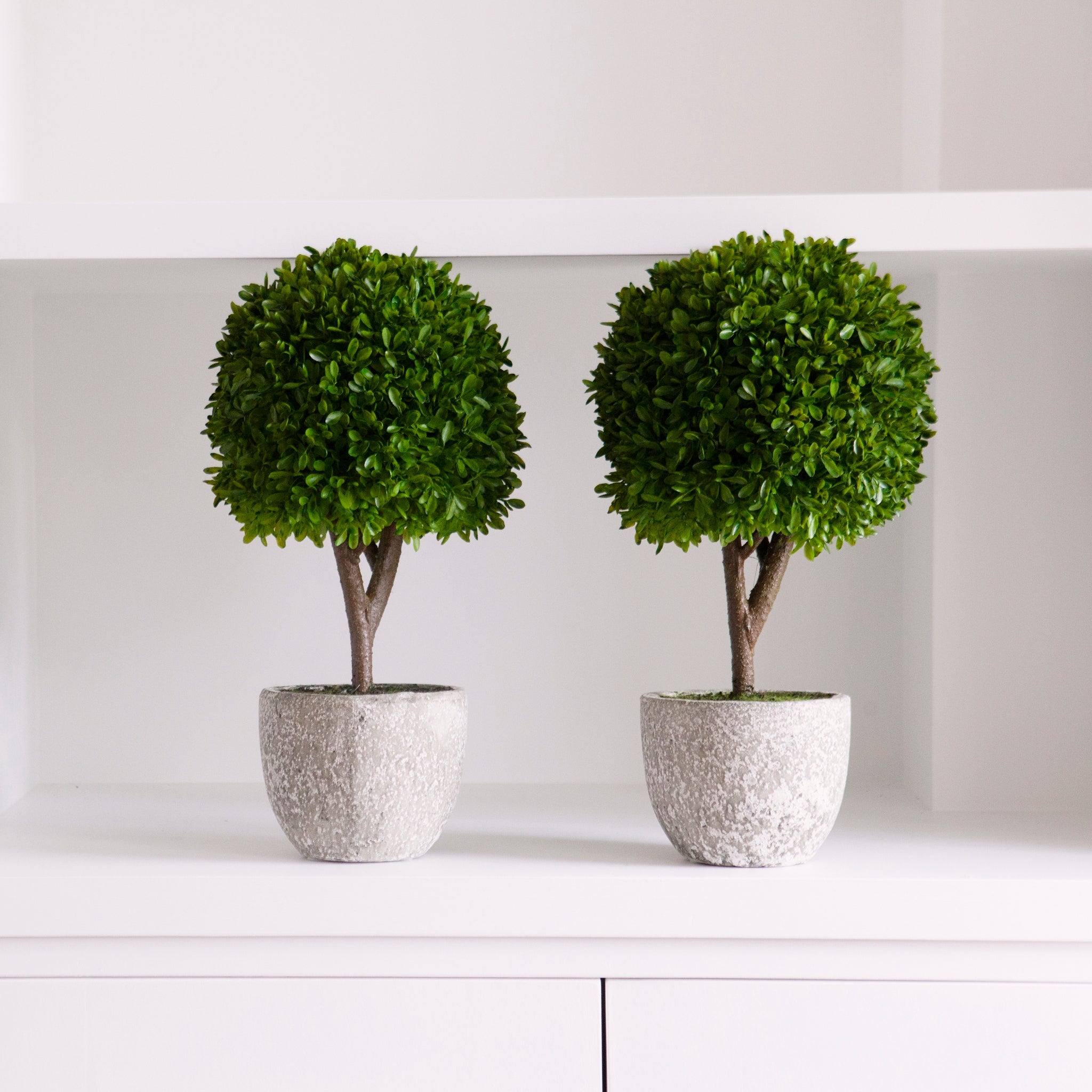 faux topiary in stone pot