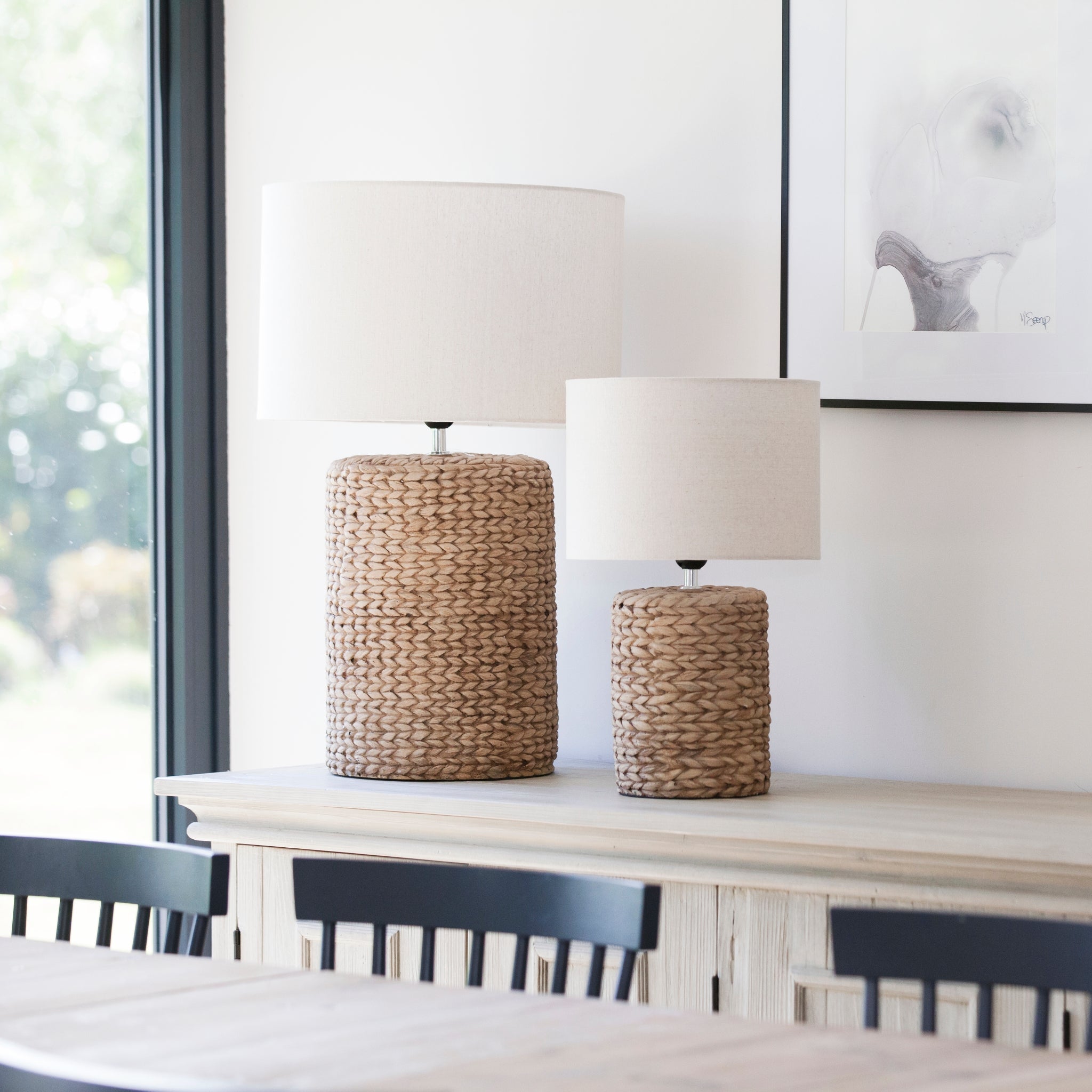A fabulous Statement Lamp with a chunky rope effect base in natural tones topped with a neutral oatmeal lampshade.