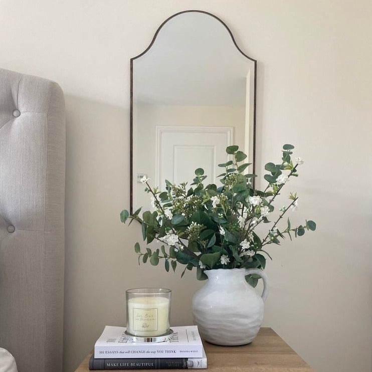 A beautiful frameless arched mirror.