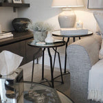 A beautiful set of two nesting tables finished crafted from metal and finished in warm bronze tones finished with a mirror top.