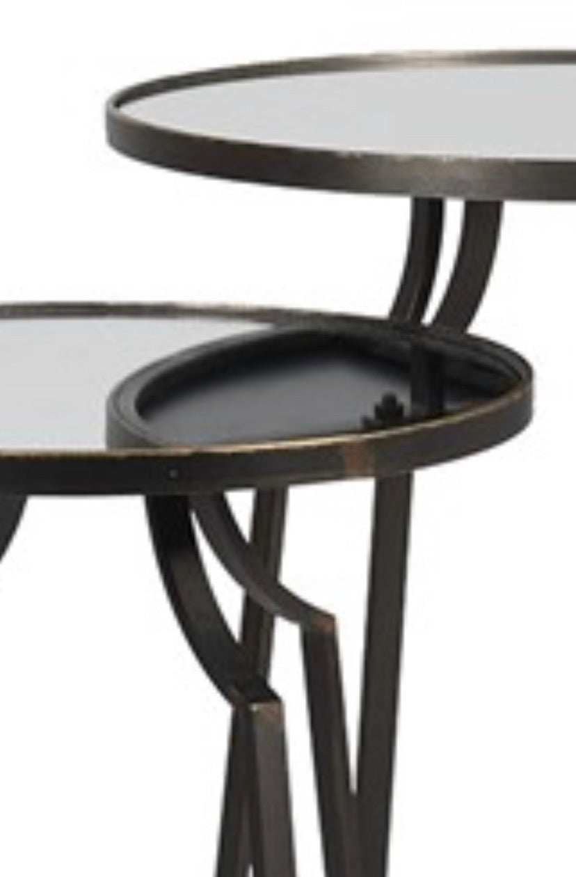 A beautiful set of two nesting tables finished crafted from metal and finished in warm bronze tones finished with a mirror top.