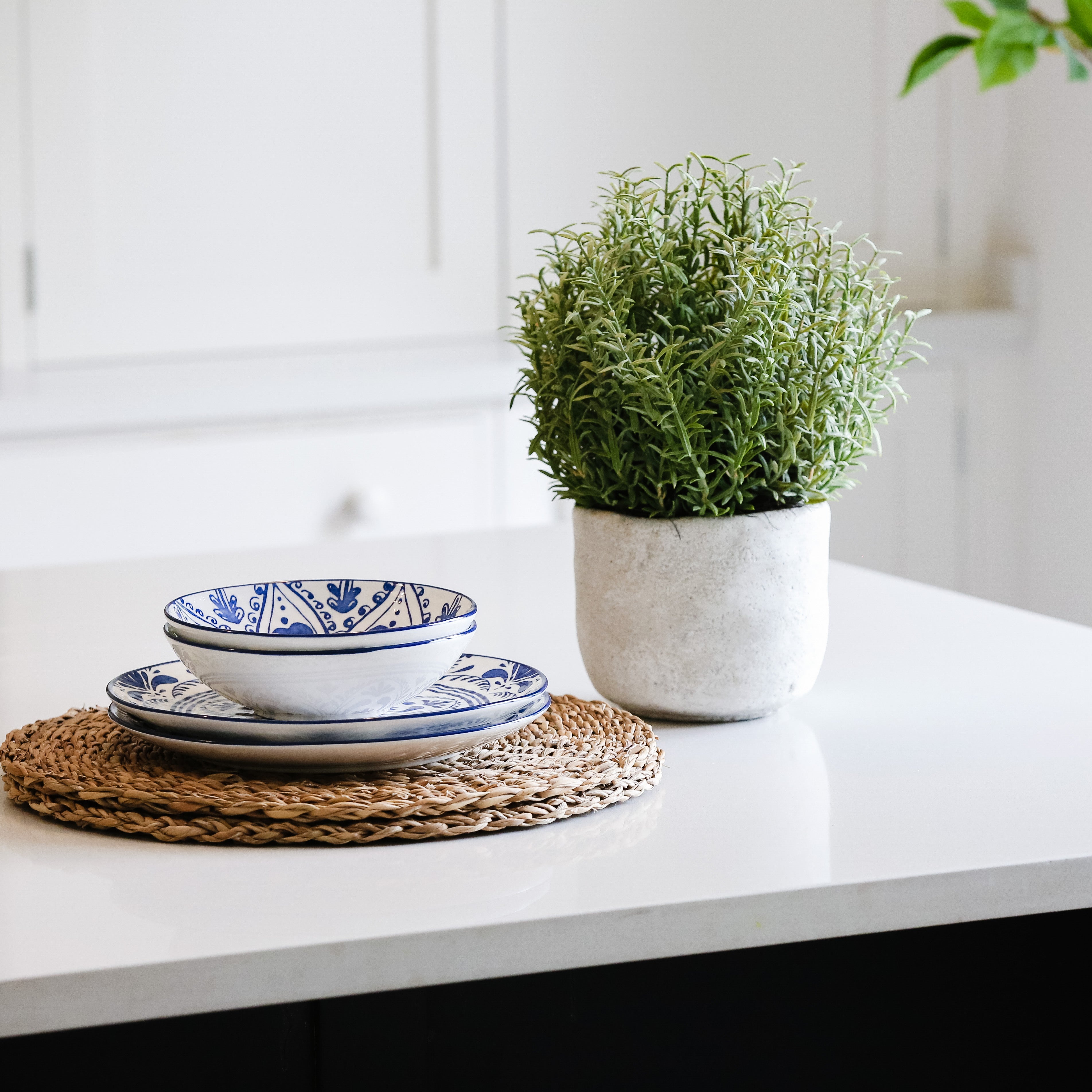 faux rosemary bush in stone pot